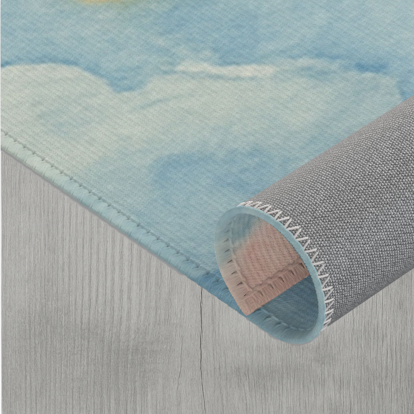 Rolled up corner of Dreamy rainbow cloud watercolor durable rug for nursery or playroom