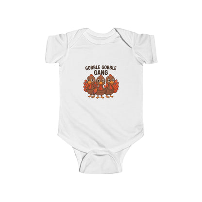 White baby thanksgiving onesie with 'Gobble Gobble Gang' text and turkey graphics on a white background.