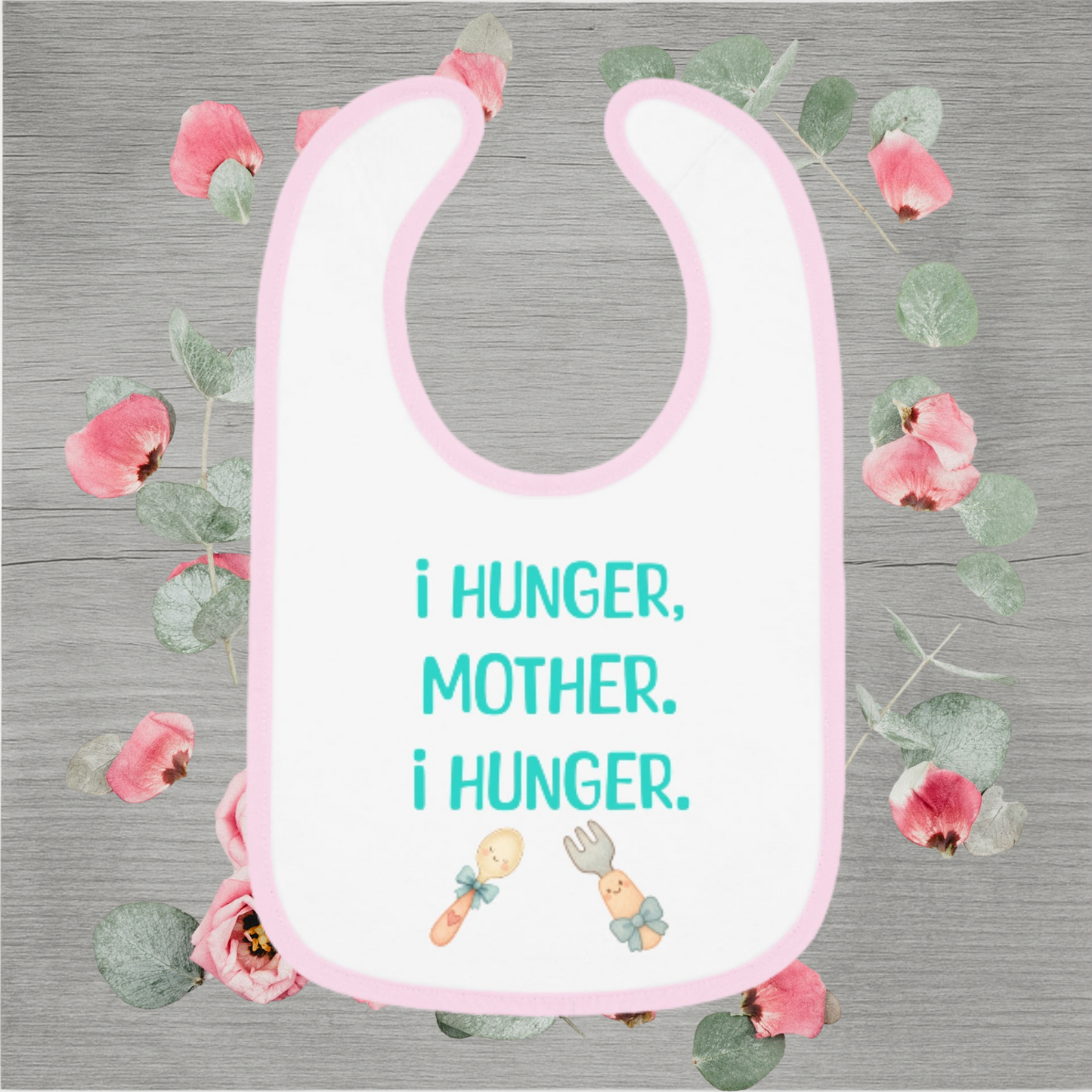Funny baby bib with pastel pink trim and the quote 'I Hunger, Mother. I Hunger.' printed in teal with cute fork and spoon illustrations.