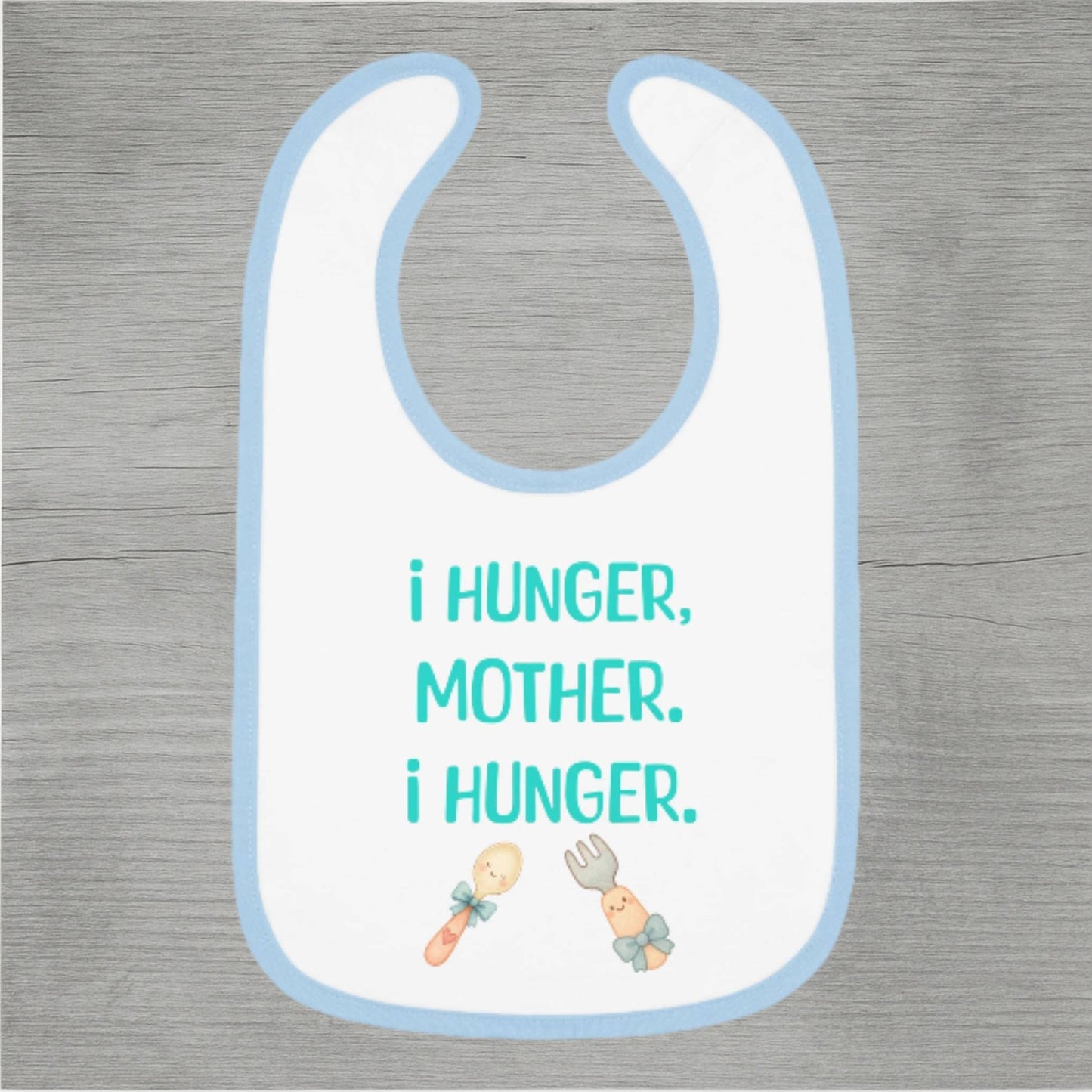 Baby bib with text 'I hunger, mother. I hunger.' on a wooden surface