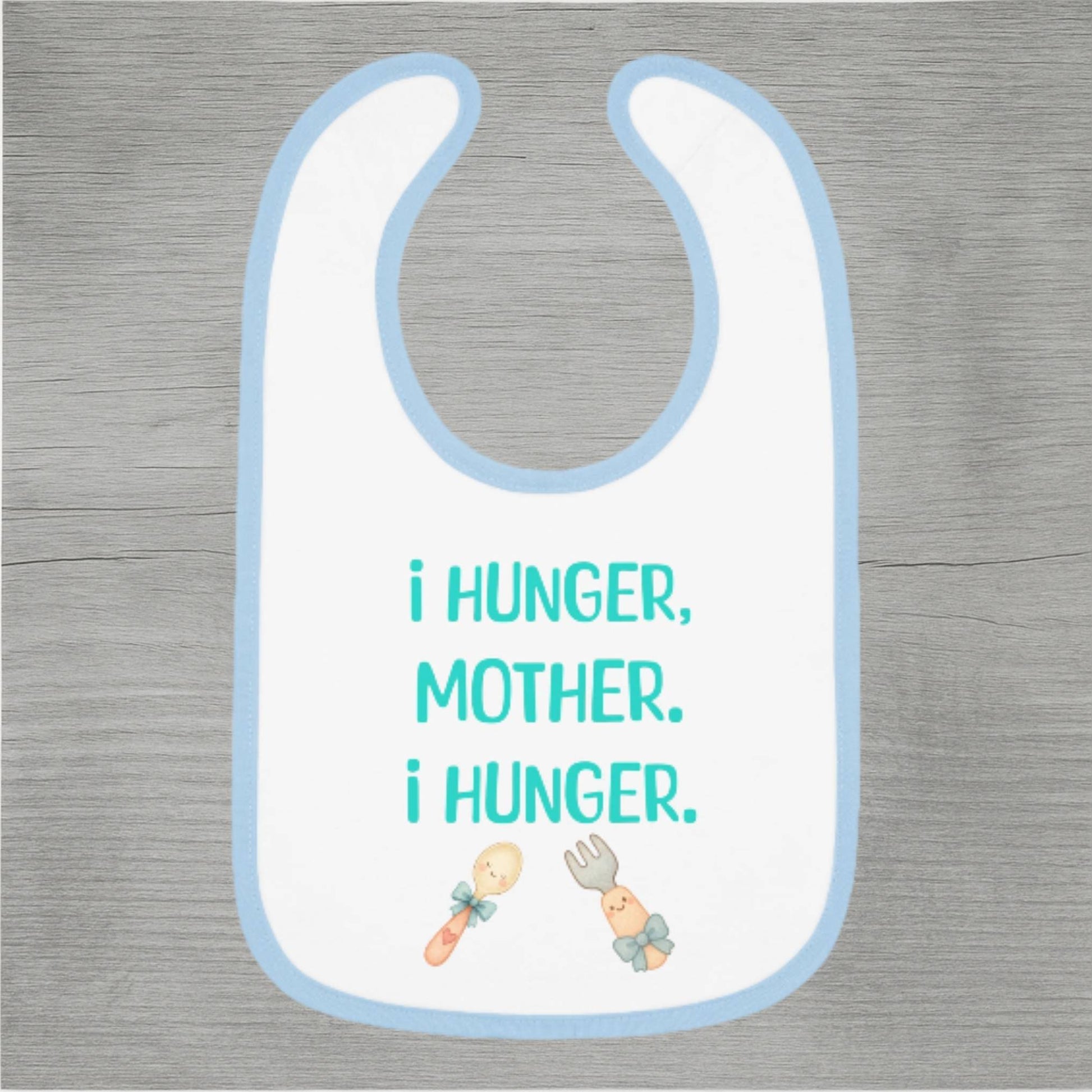 Baby bib with text 'I hunger, mother. I hunger.' on a wooden surface
