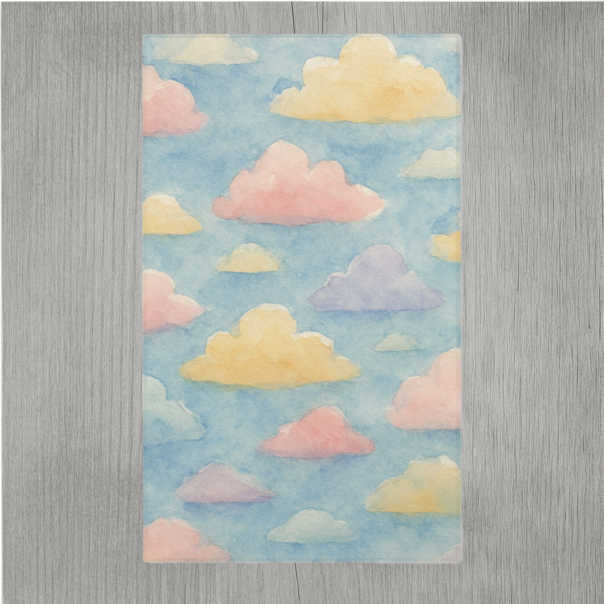 Watercolor nursery rug featuring dreamy clouds and hemmed edges for added durability
