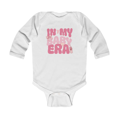 White long sleeve baby onesie with pink retro text ‘In My Baby Era’.