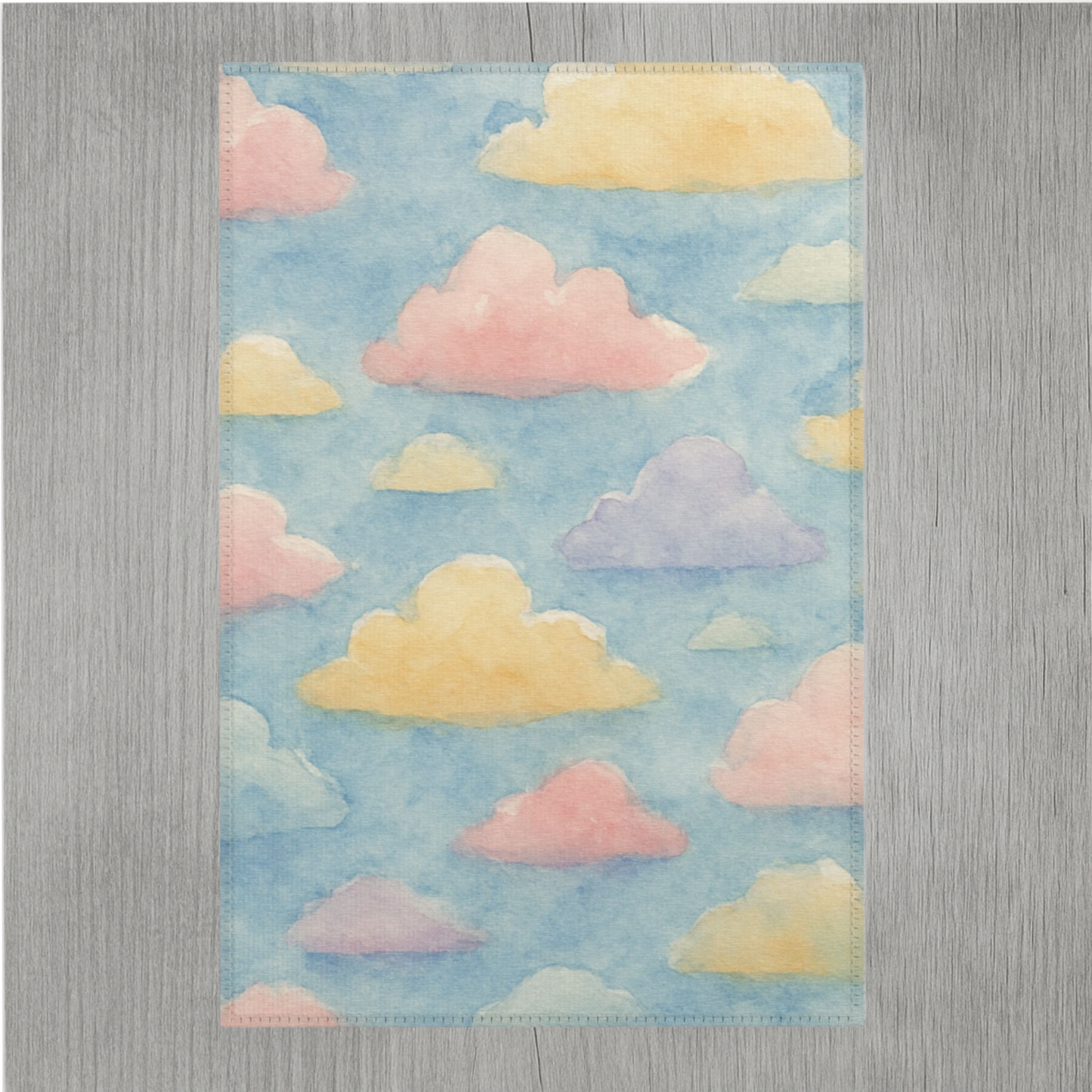 Pastel rainbow watercolor cloud area rug with vibrant soft colors and hemmed edges for durability, designed for modern home décor.